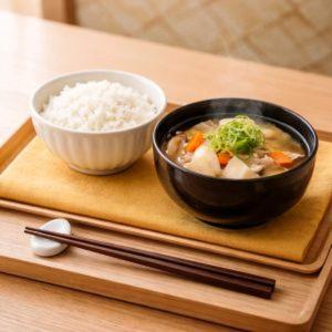 a bowl of soup and a bowl of rice on a tray at Hotel Piatt Nagoya in Nagoya