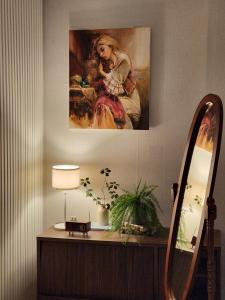 a painting of a woman sitting on a table at Gaegum Moonlight Stay in Busan