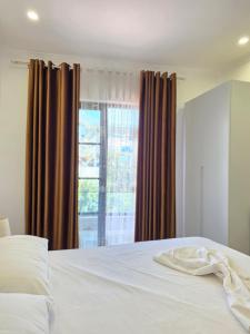 a bedroom with a white bed and a window at Crown Villa in Golem