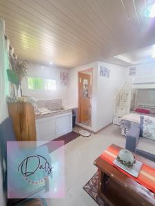 a living room with a bed and a table at Dals Accommodation pad in Baguio