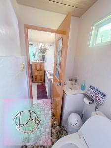 a bathroom with a toilet and a sink at Dals Accommodation pad in Baguio