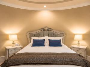 a bedroom with a large bed with blue pillows at Campus Haven Near YVR UBC Downtown in Vancouver
