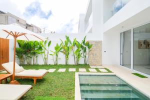 an external view of a house with a swimming pool at Blanca Karma Villas in Uluwatu