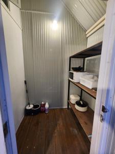 a small room with wooden floors and a room with a shelf at Porjai's Lakeview in Phetchabun