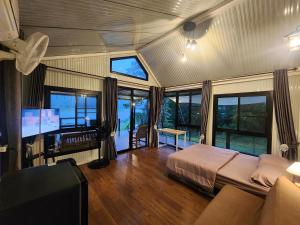 a bedroom with a bed and a tv in a room at Porjai's Lakeview in Phetchabun