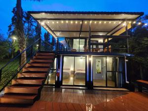 a house with a staircase leading up to it at Porjai's Lakeview in Phetchabun +9 photos