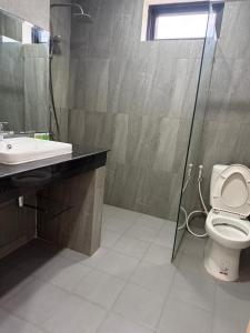 a bathroom with a toilet and a sink and a shower at Skyline hotel in Phnom Penh