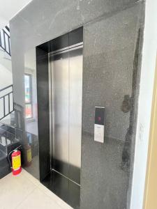 a stainless steel elevator in a building at Skyline hotel in Phnom Penh