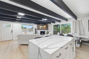 a living room with a white table and chairs at Remodeled Yosemite Cabin Sleeps 12 in Groveland