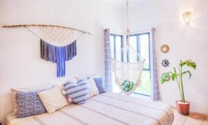 a living room with a couch and a window at Sayulita Boutique Suites - Pool Access, Kitchen, Walk to Beach in Sayulita +77 photos