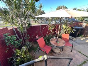 a table and two chairs and an umbrella at Sacred Heart House in Montebello