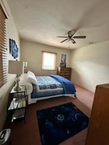 a bedroom with a bed and a ceiling fan at Sacred Heart House in Montebello