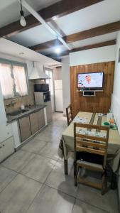 a kitchen and dining room with a table and a tv at TRINIDAD in San Juan +12 photos