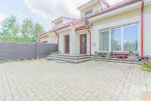 a house with a brick driveway in front of it at Red Era Glamping in Vilnius