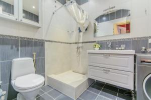 a white bathroom with a toilet and a sink at Red Era Glamping in Vilnius