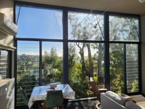 a room with a table and a large window at Tamar Ridge Winery Apartments in Grindelwald