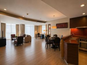 a kitchen and living room with a table and chairs at Urbana Sathorn Hotel, Bangkok in Bangkok +44 photos
