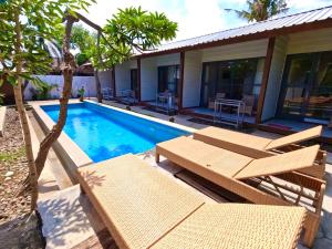 a villa with a swimming pool and a house at Villa PhyPhy in Gili Trawangan +9 photos