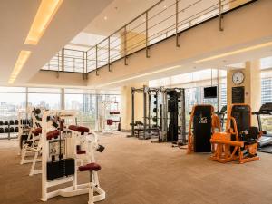 a gym with lots of exercise equipment in a building at Urbana Sathorn Hotel, Bangkok in Bangkok