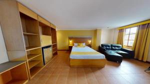 a hotel room with a bed and a couch at Swiss Chalet in Angeles +30 photos
