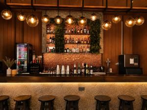 a bar with stools in front of a counter at Urbana Sathorn Hotel, Bangkok in Bangkok