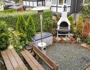 a backyard with a barbecue and a bench and a grill at Ferienhaus Olsberg in Olsberg