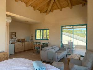 a kitchen and living room with a couch and a table at מול האופק horizonview in Kammon
