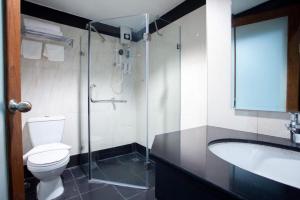a bathroom with a toilet and a sink and a shower at Vince Sakon in Sakon Nakhon