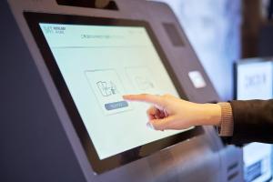 a persons hand pointing at a computer screen at Hotel B4T Kakunodate in Senboku
