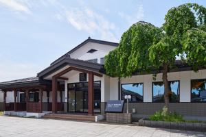 a building with a tree in front of it at Hotel B4T Kakunodate in Senboku
