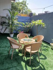 a patio with two chairs and a table and two chairs at Bell Rooms Hotel in Noida