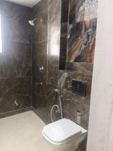 a bathroom with a toilet and a shower at Bell Rooms Hotel in Noida +24 photos