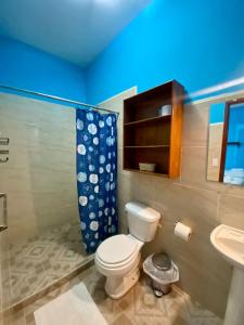 a bathroom with a toilet and a sink at Hotel del Sur in San Juan del Sur