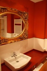 a bathroom with a sink and a mirror at Apartamentos Rincón del Puerto in San Vicente de la Barquera