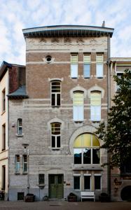 a tall brick building with a round top at @Couche Couche in Antwerp
