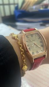 a woman holding a gold watch on her wrist at Hamsiah in Sandakan