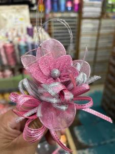 a person is holding a pink flower ornament at Hamsiah in Sandakan