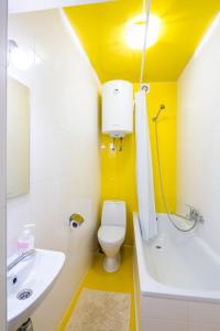 a bathroom with a white toilet and a sink at Apartment on Pekarska street зі світлом! in Lviv