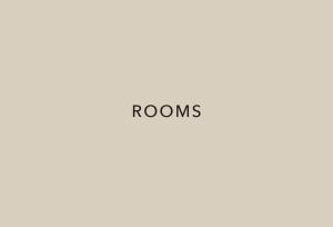 a sign with the word rooms on a wall at One Fukuoka Hotel in Fukuoka