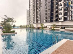 a large swimming pool in front of two tall buildings at Trellis Residence by RR JBcity in Johor Bahru +39 photos