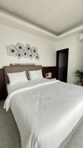 a bedroom with a large white bed with white pillows at Papayas 2 Villa in Yogyakarta +8 photos