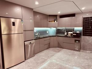 a kitchen with a stainless steel refrigerator and appliances at Thịnh Vượng Villa in Dong Hoi