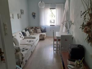 a living room with a couch and a table at Dream house steps from sea in Pídima Kyrás