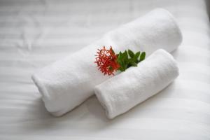 two toilet paper rolls with a red flower in them at BlueHome Vientiane in Vientiane +27 photos