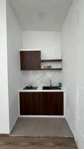 a kitchen with a sink and a counter top at Papayas 2 Villa in Yogyakarta