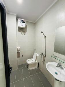 a bathroom with a toilet and a sink at Khách sạn AMI in Vinh +32 photos