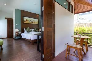 a bedroom with a bed and a table and chairs at The La-Ngu Boutique in Langu +25 photos