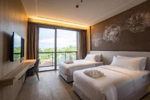 a hotel room with two beds and a large window at Riverton Hotel in Samut Songkhram +54 photos