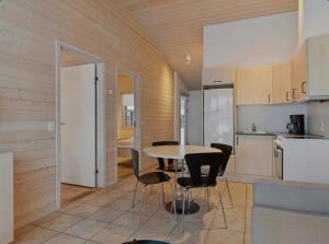 a kitchen and dining room with a table and chairs at Ideal Holiday Apartment For Active Relaxation in Pandrup