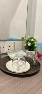 a table with a plate and glasses on a table at 1st Inn Hotel Klang Sentral Meru in Klang +30 photos